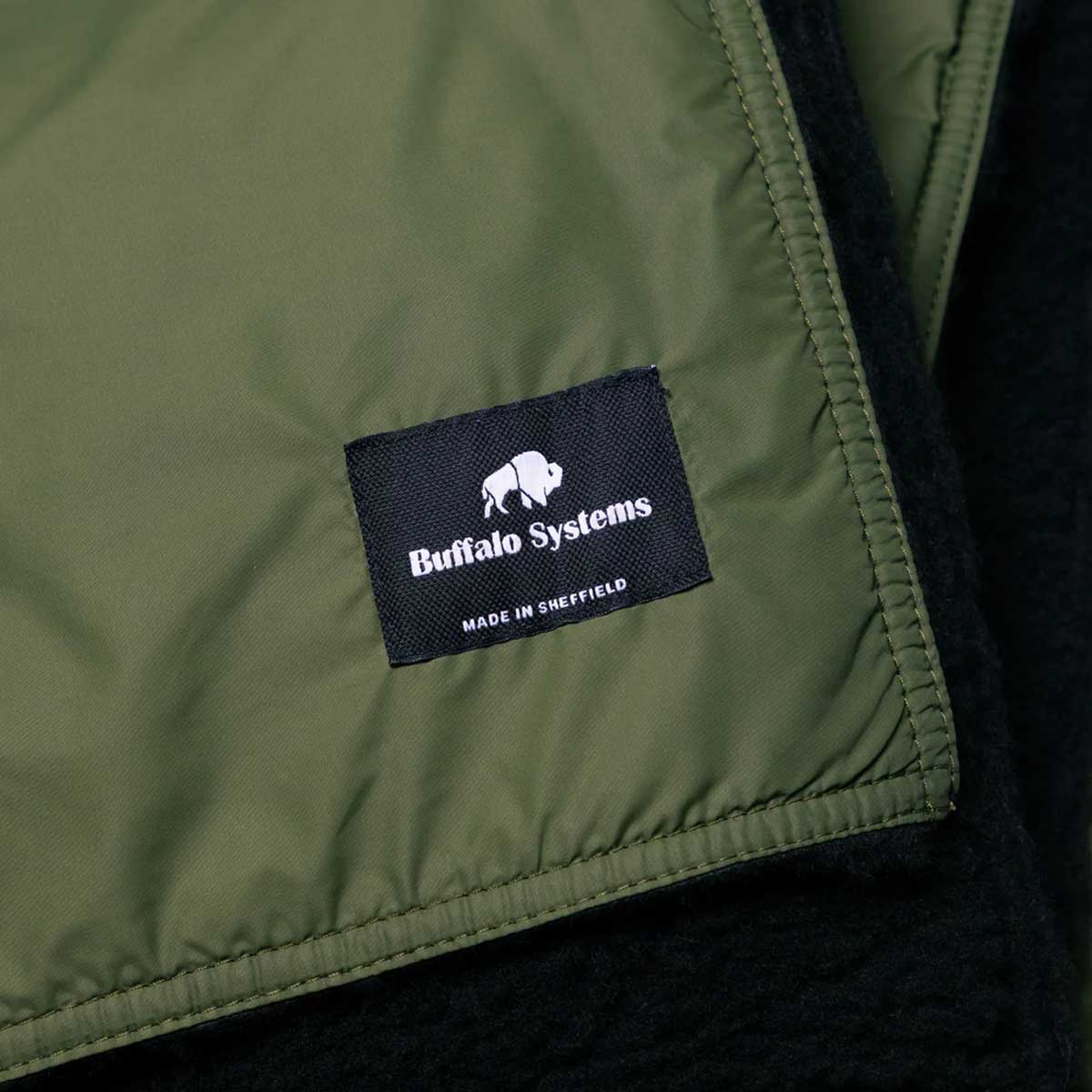 close up of green buffalo field blanket