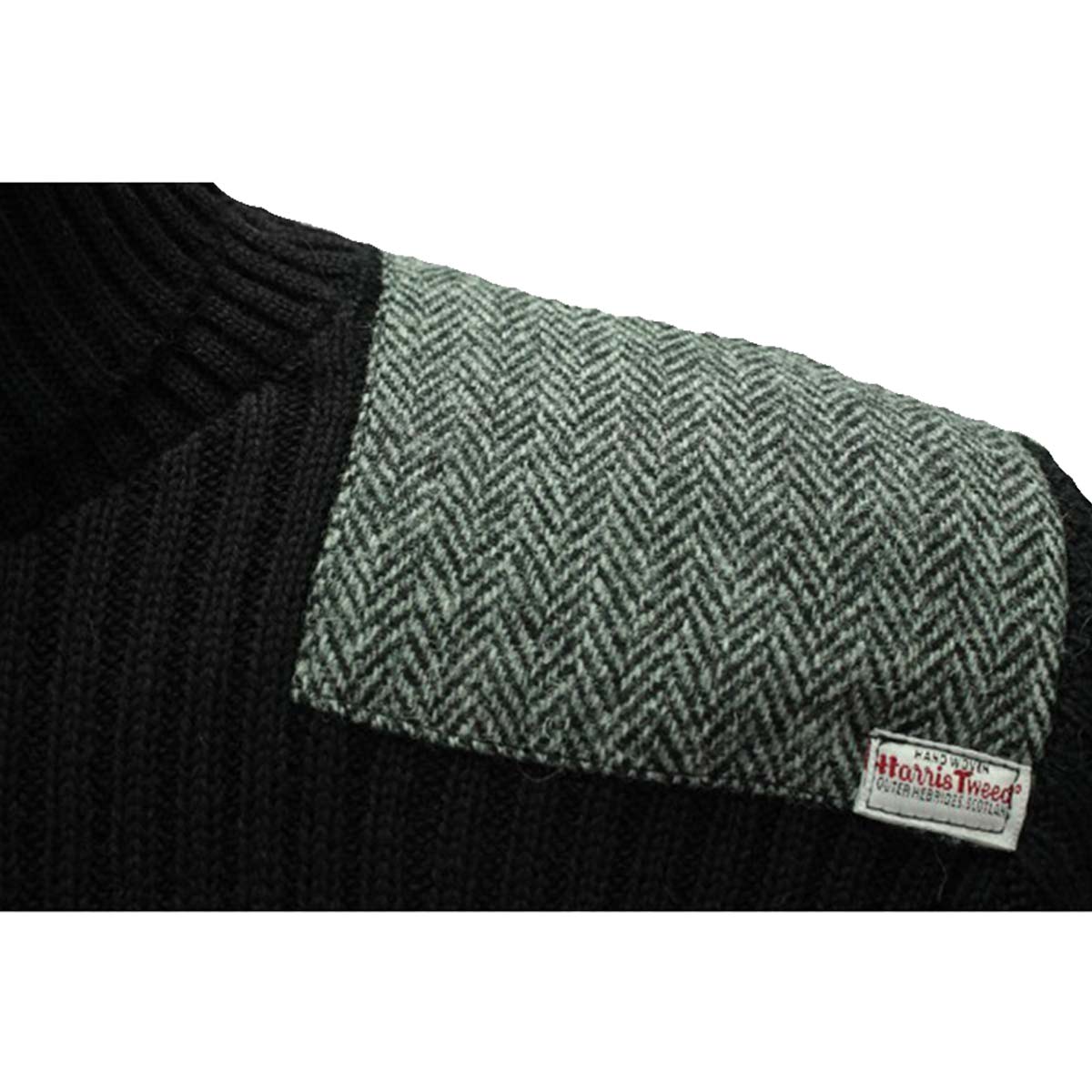 close up patch on ghillie roll neck woolly pully sweater with harris tweed patches