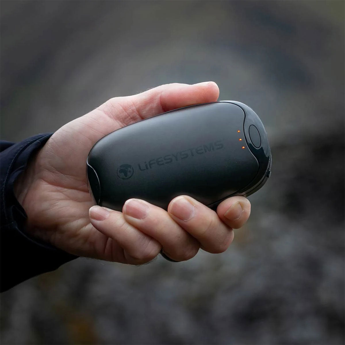 lifesystems usb dual palm rechargeable hand warmer and power bank in use